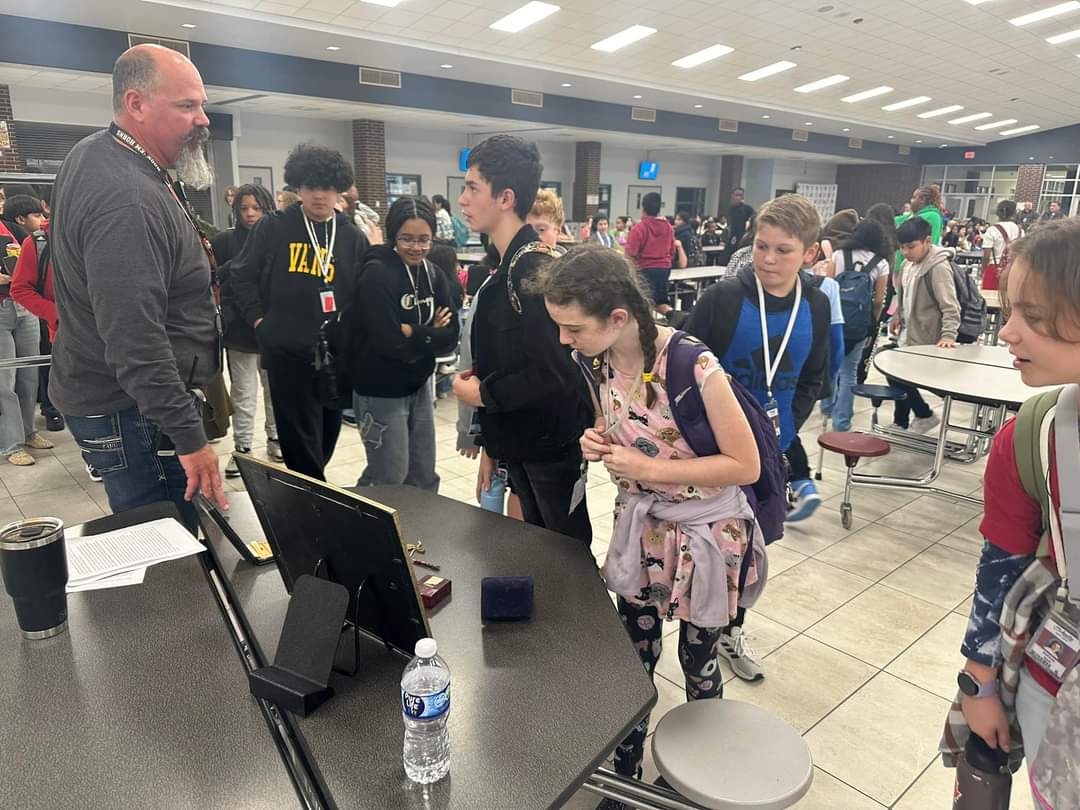 WCSchultzJH's tweet photo. Today, our very own Mr. Robinson shared the story of how a veteran, his grandfather, impacted his life because of his service. Our 6th graders were inspired by the story and honored that Mr. Robinson shared his story and showed his war memorabilia. Happy Veterans Day #TheSJHWay https://t.co/vOisph00fn
