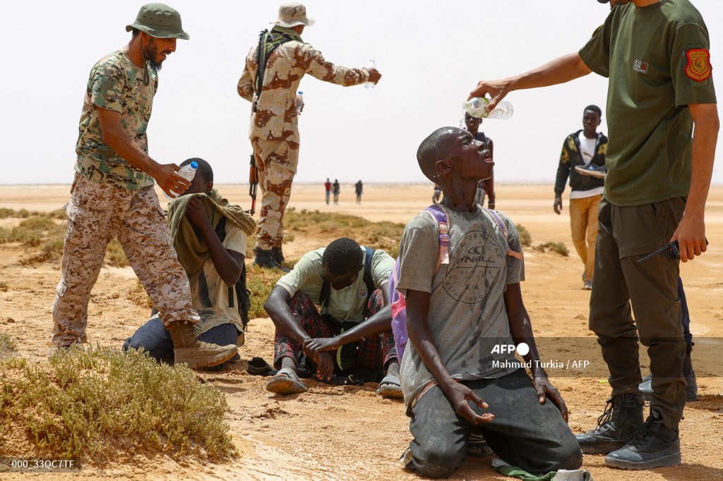 AFP photographer Mahmud Turkia has won the Grand Prix Varenne. Taken on July 30, 2023, the photograph shows the moment when Libyan border guards provide water to a group of Sub-Saharan African migrants collapsed from exhaustion on the reddish-brown desert sand, near Al'Assah.