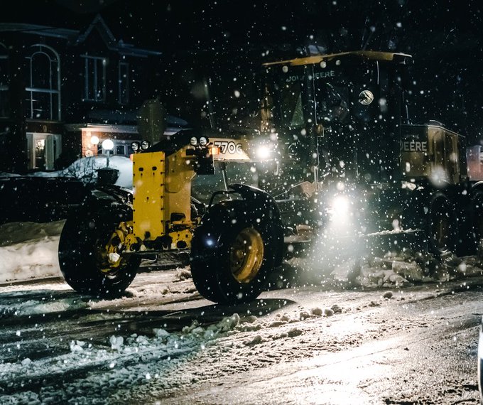 A snow plow on a snowy street