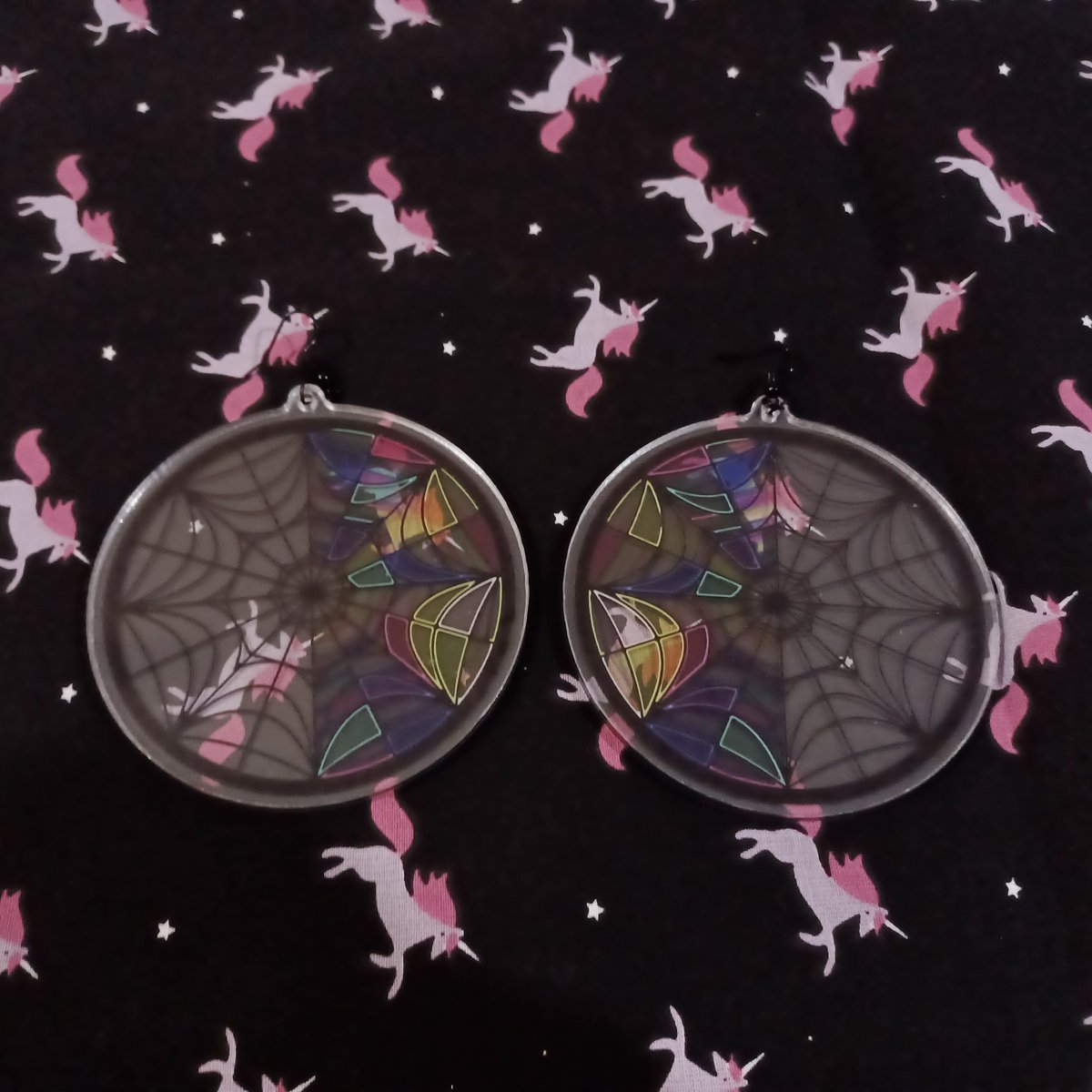 TapixT_'s tweet image. a particular favorite of my designs are from Wednesday! I have a combo keychain set of Wenclair, as well as window stickers and earrings (both partially transparent!) 

#Wednesdaynetflix #wenclair #wednesdaywindow #gothic #stainedglass #theaddamsfamily #wednesdayaddams