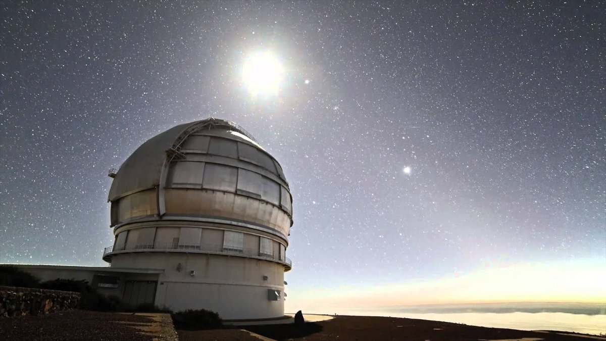 StrangeXScience's tweet photo. The Gran Telescopio Canarias is a total monster of a telescope – absolutely massive. It's perched up on a mountain on the island of La Palma, which is one of Spain's Canary Islands. The views up there? Incredible!

It's the biggest optical telescope in the world - its primary mirror that's a whopping 10.4 meters in diameter. That's like, "see the sparkle in a distant star's eye" kind of power. It's made up of 36 separate hexagonal segments that work together as one giant mirror. 

The location is pretty key, too. It's up there at about 2,267 meters above sea level, on this old volcanic peak called Roque de los Muchachos. The air is super clear, which means the telescope gets a really crisp view of the cosmos. Plus, the Canary Islands have these strict light pollution laws to keep it dark and lovely for stargazing.

Astronomers use the Gran Telescopio Canarias to peek at all sorts of celestial wonders, from stars and planets in our own galaxy to distant galaxies and even the elusive black holes. It's like having a VIP pass to the best show in the universe.