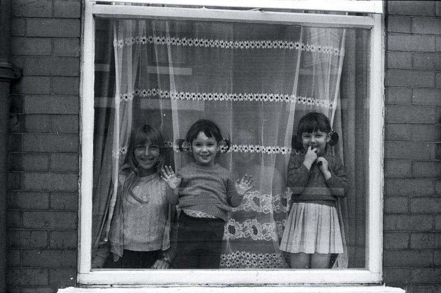 Three Children in A Window, Manchester, 1977, by Iain S.P. Reid.