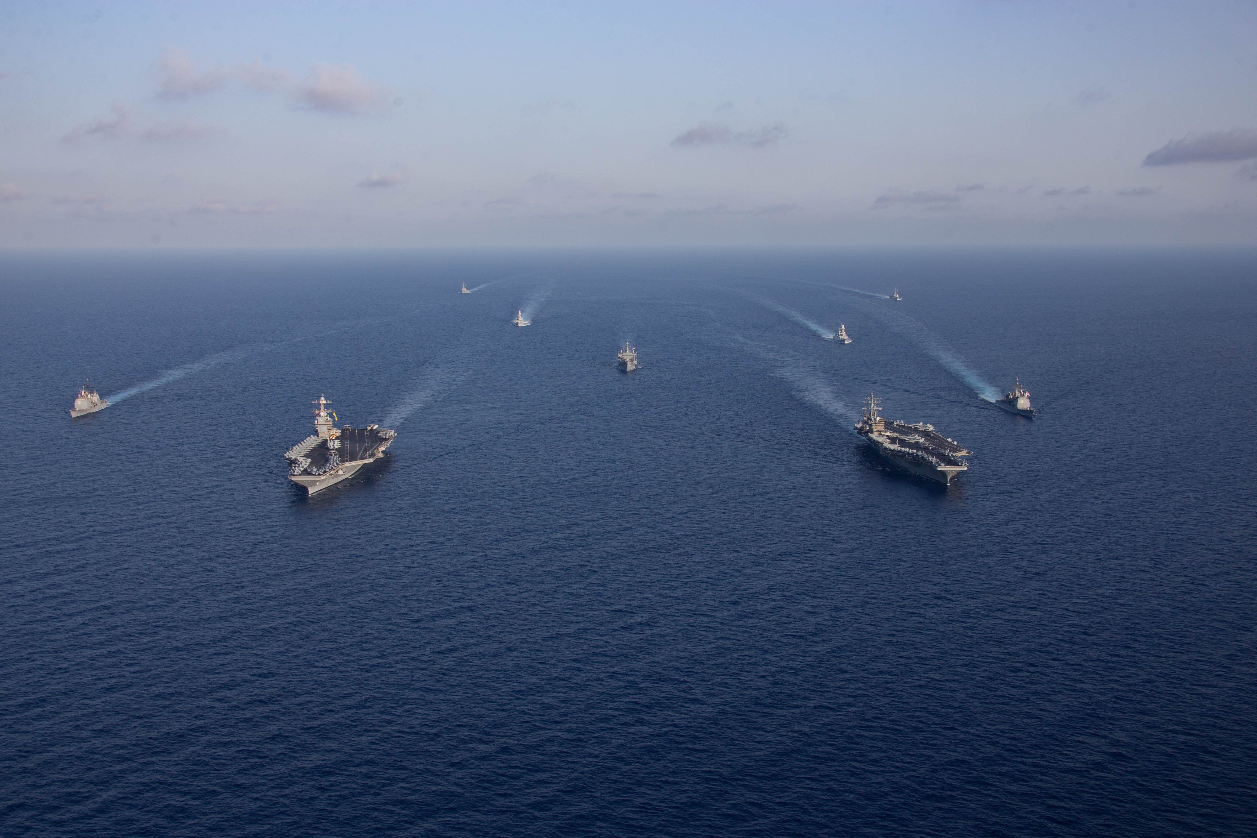 Ships from the Gerald R. Ford and Dwight D. Eisenhower Carrier Strike Groups (CSG), U.S. Sixth Fleet command ship USS Mount Whitney (LCC 20), and Italian Navy frigates Carlo Margottini (F 592) and Virginio Fasan (F 591) sail in formation in the Mediterranean Sea, Nov. 3, 2023. The two carrier strike groups are operating in the area at the direction of the Secretary of Defense to bolster deterrence in the region. (U.S. Navy photo by Mass Communication Specialist 2nd Class Jacob Mattingly)