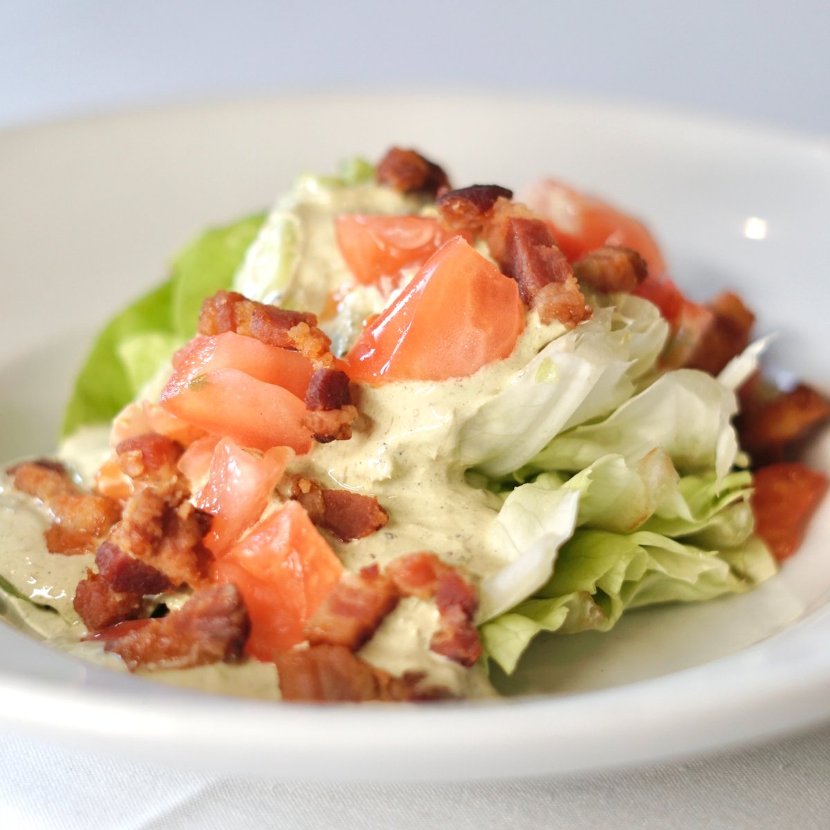 The B.L.T Wedge Salad—a fresh new way to B.L.T. 🥗
 
Discover Apolline's take on a classic, stacked with crisp butter lettuce, rich bacon lardons, ripe heirloom tomatoes, and an aromatic charred scallion vinaigrette. 

#apollinerestaurant #magazinestreet #noladining #neworleans