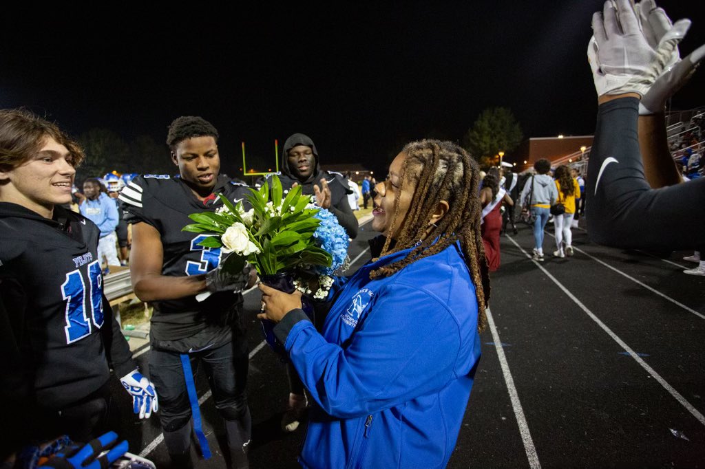 NPSchools_VA's tweet photo. Congratulations to Norview High School’s Homecoming King and Queen Omar Owens and Senai Gerrins! Thanks to the alumnae cheerleading squad for the excellent cheers! Principal Tori Jacobs-Sumbry received flowers from the football team. 💐💙🤍💐 https://t.co/zU5nxAnFjc