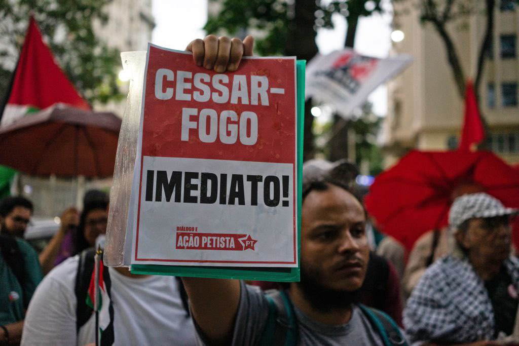 Timesofgaza's tweet photo. With symbolic shrouds, activists in Brazil protest against the lsraeli mass war crimes committed in Gaza Strip. https://t.co/7xJYcceANy