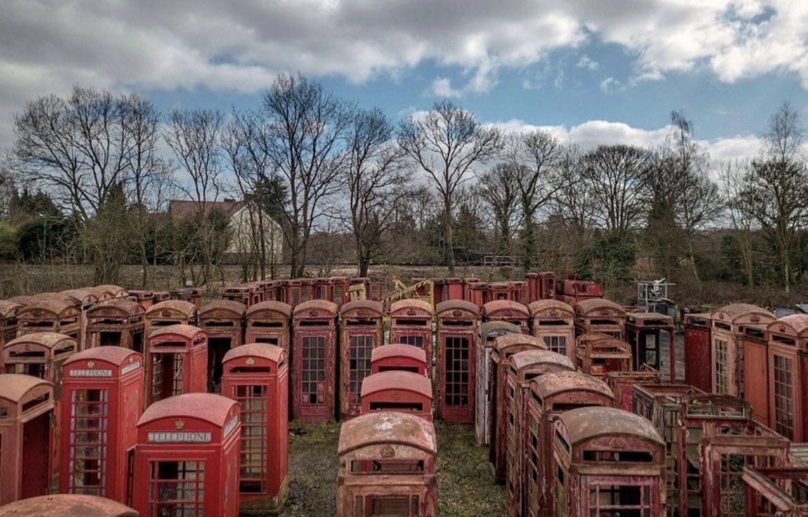 Red telephone booth cemetery on the outskirts of London

The public telephone boxes that once lined the streets of the UK, lit up the roads of Bermuda and Malta, and stood proudly on the corners of Gibraltar were designed by Sir Giles Gilbert Scott. These streamlined, brightly