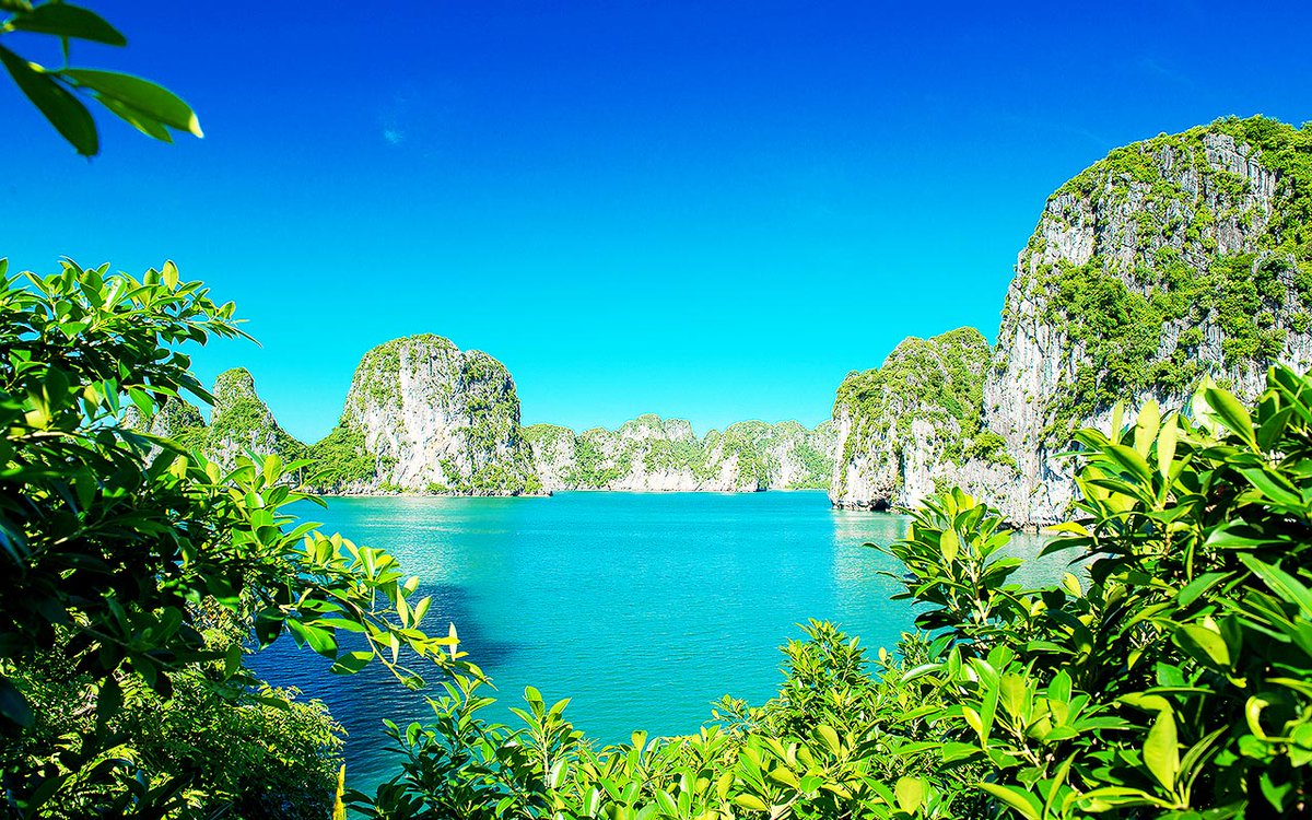Ha Long Bay, Vietnam, is a place of incredible natural beauty with magical islands and caves, turquoise seas, and stunning sunsets. This is a great place to experience natural beauty through the senses and enjoy peaceful island life. #tourism #NaturalBeauty