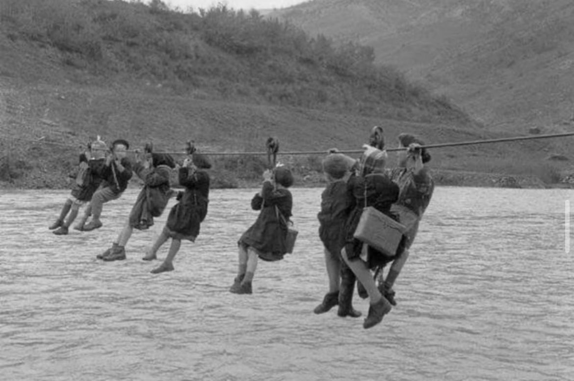 In 1959, in the vicinity of Modena, Italy, children had to cross the river, named Panaro, to reach their school using a pulley system. Previously, there was a bridge, but it had been destroyed during World War II and remained unrepaired for an extended period due to financial