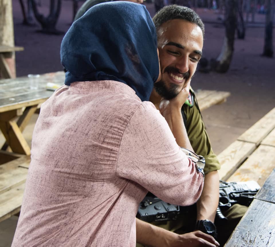 An Israeli Muslim mom kissing her son after he finished advanced combat training in the IDF.  Israel is a multiethnic, multi-religious, multicultural democracy.