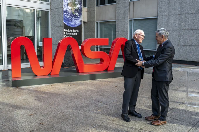 NASA Associate Administrator Bob Cabana, right, shakes hands with Richard Danne after awarding him the Exceptional Public Achievement Medal for his outstanding achievement in creating the NASA worm logotype, Monday, Nov. 6, 2023, at the Mary W. Jackson NASA Headquarters building in Washington. Photo Credit: (NASA/Keegan Barber)