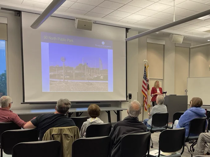 Director of Communications and Outreach Allison Albrecht gives a presentation on village updates in front of a crowd at the Schaumburg Library.
