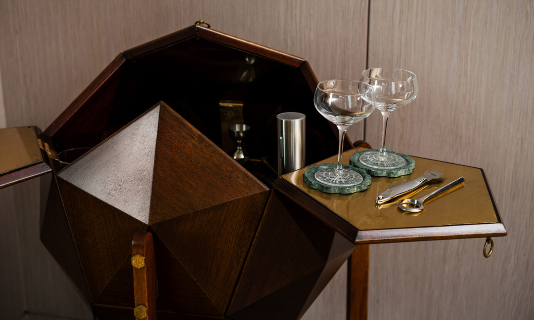 Vintage pieces were hand selected from famed designers like M. Vuillermoz Polyhedron. The mesmerizing 1960’s mahogany polyhedron shaped bar cabinet from France is the perfect centerpiece and vessel for cocktail-making🍸 in the Tribeca suite. (Photographed by @joethommas)