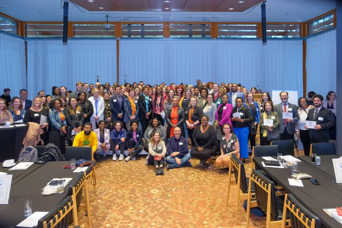 A large group of people posing at the 2023 Embassy Adoption Program Diplomatic Tea.