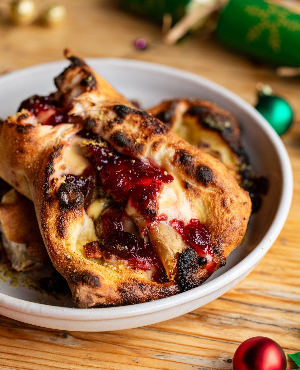 One week to go till the return of our Christmas Calzone! 🎄 A roast dinner in a folded pizza with turkey, cheddar, sage stuffing, roast potatoes, cranberry sauce, and a gravy dipping pot. 😍 Join us from next Monday ✨ - purezza.co.uk/christmas-2023 #purezza #veganchristmas #veganuk