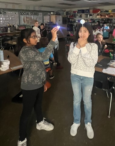 We are Nandia &amp; Joanna, the second Tweeters of the week. We are sharing a space activity we did in Science. One of us represented the sun &amp; the other  the moon. This showed us how the moon changes its phases but the actual moon shape stays the same. #21learns <a href="/21longfellow/">CCSD21 Longfellow</a>