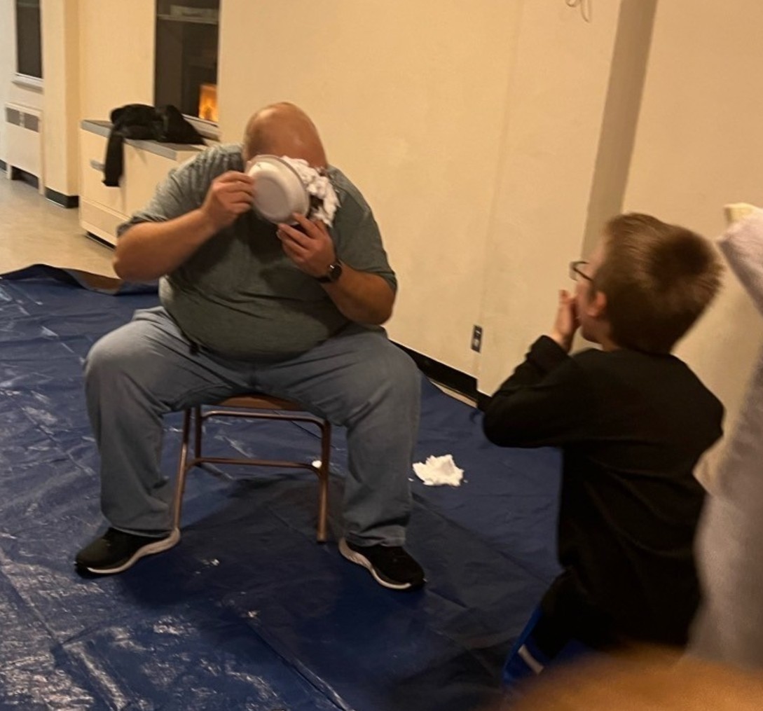 Getting hit in the face with pies of shaving cream in the face for the top sellers in the Cub Scout Pack.