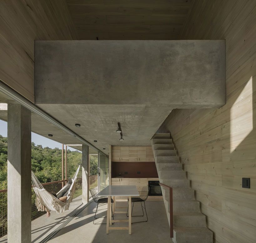 designboom's tweet photo. isolated among the trees in #argentina, this home and office is designed as a narrow concrete volume on stilts 🇦🇷🌲 https://t.co/EEm7QM5gOh