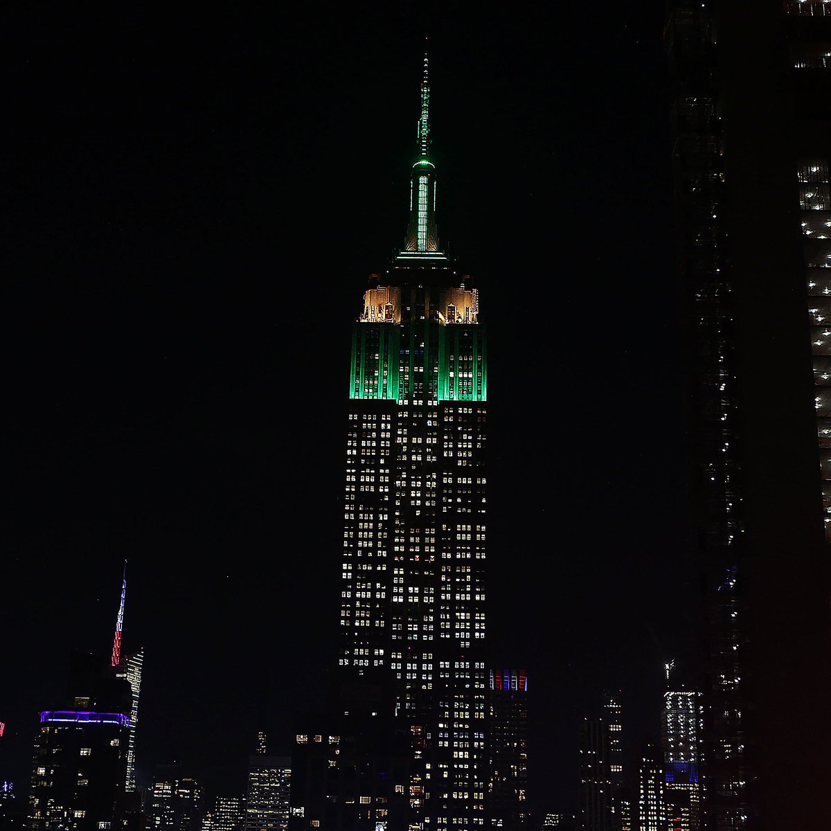EmpireStateBldg's tweet photo. Shining in green and yellow tonight to celebrate the 20th Anniversary of Elf and Buddy's first trip to New York City #elf20th @wbpictures https://t.co/ZvAGWvS2se