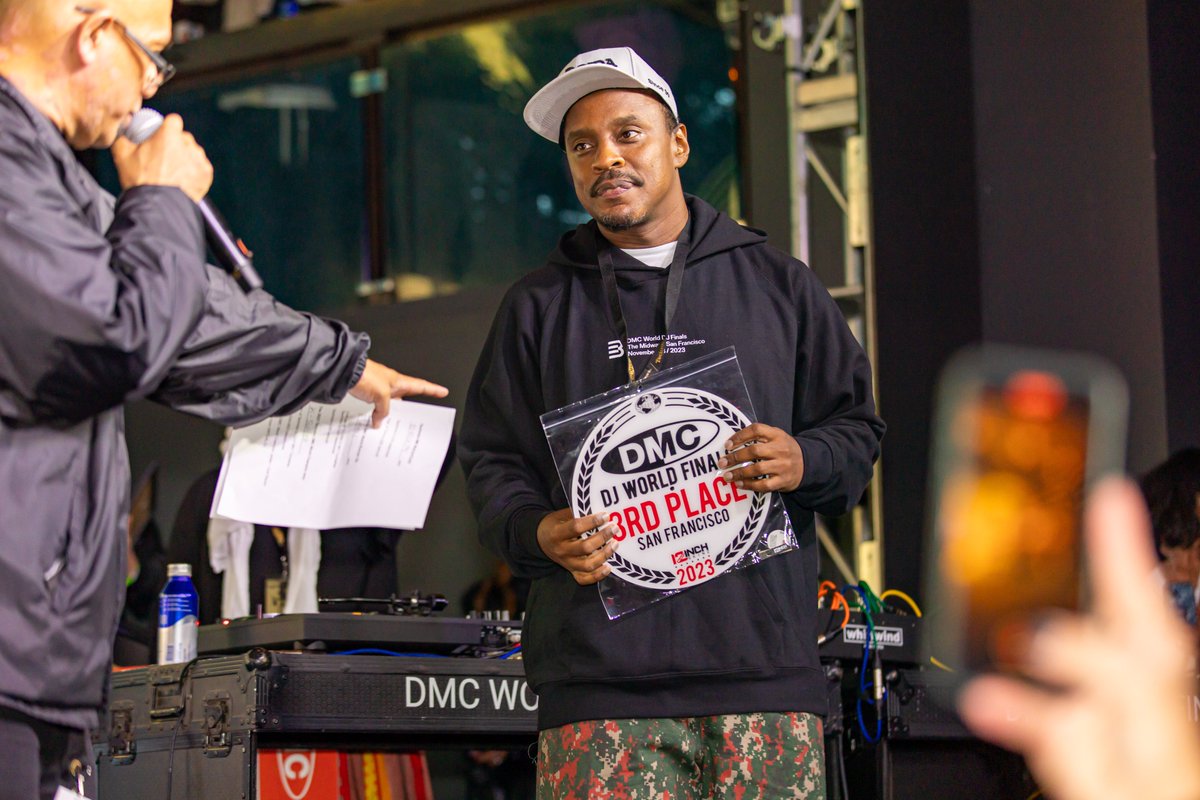 Congratulations to @DjErickJay (Brazil) on placing 3rd in the 2023 <a href="/technics/">Technics</a> DMC World Finals <a href="/Themidwaysf/">The Midway SF</a>: San Francisco. He wins Technics DJ1200 headphones + Technics AZ80 earbuds. Photo by <a href="/JeffStraw/">Jeff Straw Branding</a>. Thanks to <a href="/12inchskinz/">Twelve Inch Skinz</a> for the disc!