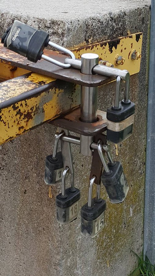This lock can be opened with 1 lock: no matter which one. 

It's a real life example of a brunnian link, a nontrivial link that becomes a set of trivial unlinked circles if any one component is removed.