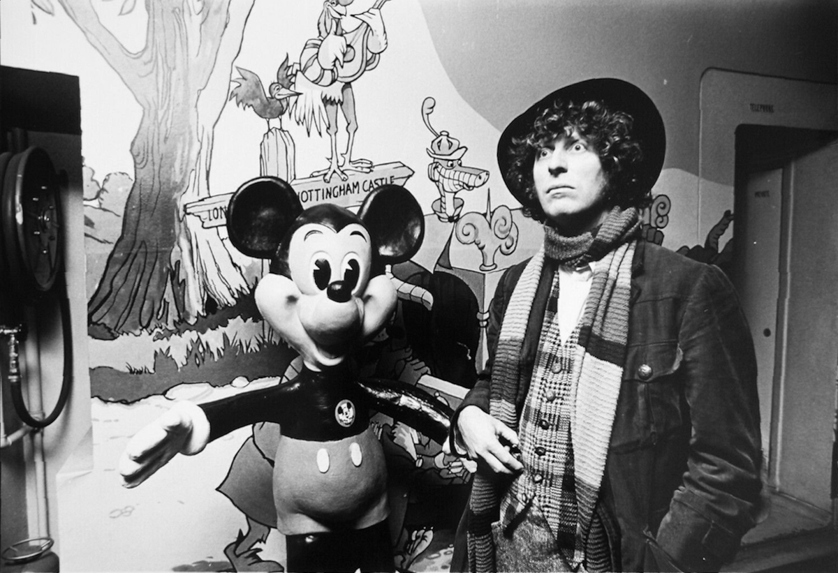 claytonhickman's tweet image. New photo colourisation and restoration for you - the original unholy union of Disney and #DoctorWho as Tom Baker takes the hand of The Mouse™ on Sunday 3rd August 1975 in the Odeon ‘Disney Cinema’, St Martin’s Lane, London, during filming of his links for ‘Disney Time’.