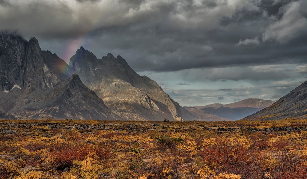 Nature's stroke of pure magic! Witnessing the birth of a vibrant rainbow at Talus Lake in the stunning Tombstone Mountains. 🌈✨