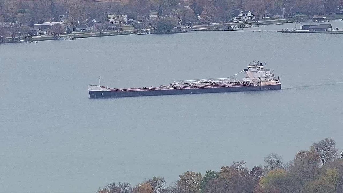 seaandcoast1's tweet photo. Night time Efforts Underway to Safely Refloat Stranded Great Lakes Freighter in St. Clair River: An Unfolding Maritime Rescue
#Michigan #GreatLakes #MarineCity #ShippingNews #AmericanCourage
Efforts persisted into the evening in a bid to dislodge a grounded Great Lakes freighter, creating a local spectacle along the St. Clair River in Michigan. As the sun dipped below the horizon this evening, the 636-foot American Courage remained steadfastly lodged in the river, drawing the attention of both television cameras and curious onlookers at a nearby park.
The ordeal commenced earlier on the morning of November 7, with reports of a Lakers vessel running aground. Fortunately, no injuries or signs of pollution were reported. The U.S. Coast Guard for the Great Lakes region received notice of the incident at 7:21 a.m., issuing a marine safety broadcast urging caution to other vessels in the vicinity of Marine City, Michigan. Nevertheless, the river's shipping channel remained unobstructed.
The American Courage, a U.S.-flagged vessel owned by Grand River Navigation, had set sail from Stoneport on Lake Huron, en route to the Marine City Terminal to the north of Detroit, situated between Lake Erie and Lake Huron. A Coast Guard spokesperson postulated that the vessel may have "missed their turn and got stuck on the edge of the shipping channel." Laden with 20,000 tonnes of stone, the vessel awaited the assistance of tugboats to facilitate its release.
Throughout the day, concerned residents shared their observations on social media, noting a small boat circling the stranded bulker, likely assessing for damage or pollution. Initially accompanied by one tug, two additional tugboats joined the scene by evening. Social media snapshots depicted the tugs straining in their collective endeavour to extricate the vessel.
The U.S. Coast Guard confirmed that a comprehensive investigation would be launched to ascertain the cause of the grounding, with a subsequent inspection planned for potential damage once the freighter was successfully refloated.