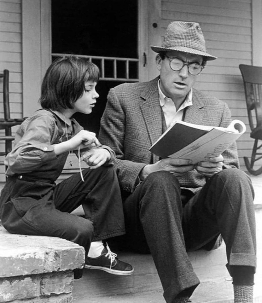 Mary Badham and Gregory Peck going over their lines on the set of the classic film "To Kill a Mockingbird" 1962. Badham, at just ten years old, delivered a remarkable performance as Scout Finch, earning an Academy Award nomination. Gregory Peck, an established Hollywood figure,