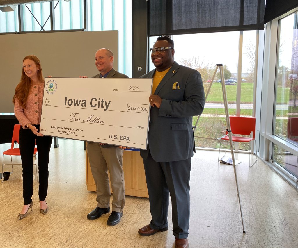 EPAregion7's tweet photo. .@EPAregion7 Administrator Meg McCollister presented Iowa City Mayor Bruce Teague and Iowa City Public Works Director Ron Knoche with a ceremonial check for $4 million during an event celebrating the City's Solid Waste Infrastructure for Recycling (SWIFR) Grant. https://t.co/Ygz2tSDhuG
