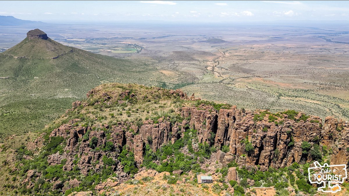 MarkSham's tweet photo. So many of you have suggested we visit The Valley of Desolation over the last few months and we finally got the opportunity to experience the beautiful views for myself. Now let me share them with you ❤ After leaving Nieu-Bethesda on Saturday morning, Jeandre and I decided to "Sho't Left". All I can say is this was the best detour I've ever made 🇿🇦❤️

The first pic I took as we got out the car. The second is a shot of the view point from the ground. The third is a bird's eye view of what you see from the view point. Look how small it is. The last pic is bird's eye view from a different angle. You have to open them all to see what I mean.

The Valley of Desolation in the Eastern Cape is both a geological phenomenon and a unique Karoo landscape that surrounds the town of Graaff-Reinet.

Sheer cliffs and precariously balanced columns of Dolerite rise 120 metres from the valley floor against the  backdrop of the vast plains of the Camdeboo. The internet tells me this is the product of volcanic and erosive forces of nature over 100 million years.

There is no substitute for what the human eye can see vs. what a camera can capture, but I hope these pictures give you a small idea of how incredible the scenery is.

This is exactly why I love road tripping across South Africa. You're driving along and you see a sign. You look over at your mate, you both nod, and the next minute you're driving in the opposite direction to an unknown adventure. When all is said and done, you're filled with joy having taken the leap of faith.

South Africa is the most beautiful country on earth and it deserves time to explore. I hope these pictures from our #LATRoadTrip inspire you to do just that. Our video from this road trip will be up in 4-6 weeks 🥰

PS. Big love to @SasolSA, @KiaSouthAfrica, and @Veldskoenshoes for enabling us to capture some of the beauty of this road trip. The entire aim is to entice you to plan your own road trip and experience the magic for yourselves 🇿🇦❤️