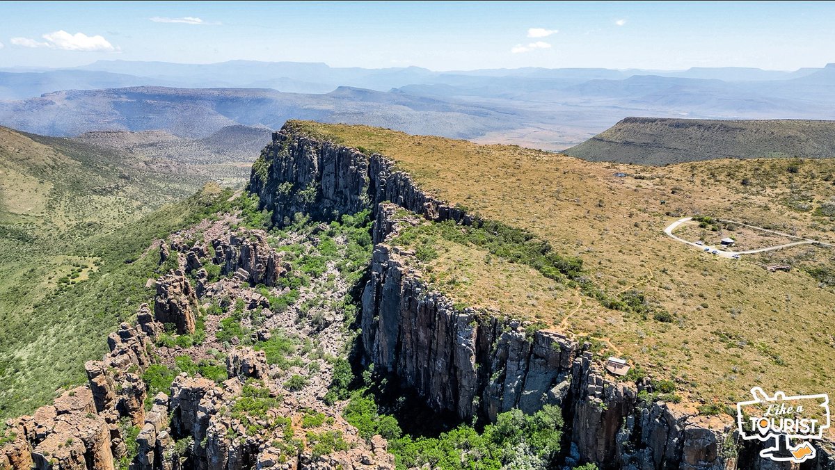 MarkSham's tweet photo. So many of you have suggested we visit The Valley of Desolation over the last few months and we finally got the opportunity to experience the beautiful views for myself. Now let me share them with you ❤ After leaving Nieu-Bethesda on Saturday morning, Jeandre and I decided to "Sho't Left". All I can say is this was the best detour I've ever made 🇿🇦❤️

The first pic I took as we got out the car. The second is a shot of the view point from the ground. The third is a bird's eye view of what you see from the view point. Look how small it is. The last pic is bird's eye view from a different angle. You have to open them all to see what I mean.

The Valley of Desolation in the Eastern Cape is both a geological phenomenon and a unique Karoo landscape that surrounds the town of Graaff-Reinet.

Sheer cliffs and precariously balanced columns of Dolerite rise 120 metres from the valley floor against the  backdrop of the vast plains of the Camdeboo. The internet tells me this is the product of volcanic and erosive forces of nature over 100 million years.

There is no substitute for what the human eye can see vs. what a camera can capture, but I hope these pictures give you a small idea of how incredible the scenery is.

This is exactly why I love road tripping across South Africa. You're driving along and you see a sign. You look over at your mate, you both nod, and the next minute you're driving in the opposite direction to an unknown adventure. When all is said and done, you're filled with joy having taken the leap of faith.

South Africa is the most beautiful country on earth and it deserves time to explore. I hope these pictures from our #LATRoadTrip inspire you to do just that. Our video from this road trip will be up in 4-6 weeks 🥰

PS. Big love to @SasolSA, @KiaSouthAfrica, and @Veldskoenshoes for enabling us to capture some of the beauty of this road trip. The entire aim is to entice you to plan your own road trip and experience the magic for yourselves 🇿🇦❤️