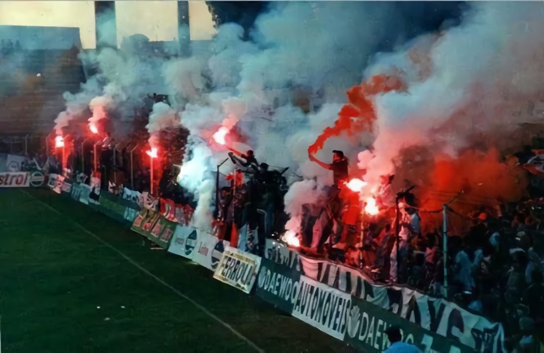 CurtaVermelha's tweet photo. Não há um adepto do Benfica, seja ele canalizador, médico ou advogado, tenha 14 anos ou 84, que não olhe para esta imagem e não tenha saudade.

Os adeptos do Benfica gostam das suas claques. Gostam dos ambientes que elas são capazes de trazer. Gostam de ver espetáculos com tochas (que não envolvam arremessos de tochas). Gostam das tifos orgânicas organizadas por adeptos e não pelo clube.

As claques terão sempre o debate ganho no que toca aos adeptos. Desde que cumpram os mínimos olímpicos da civilidade.

Neste momento, há um pequeno grupo dentro das claques que utiliza as claques como desculpa para distribuir pancada em inocentes e exibir os seus comportamentos de macho alfa.

Esse pequeno grupo não só está a prejudicar o clube como está também a prejudicar as próprias claques e os restantes membros (a maioria) das claques.

Ninguém tem problemas com as claques per se. Os adeptos adoram claques. Só que adoram mais poder ir ao Estádio sem estarem preocupados com a possibilidade de levarem com uma tocha na cabeça.

O problema não são as claques, nem a maioria dos membros das claques. O problema são as pessoas que utilizam as claques para cometer crimes. Os criminosos dentro das claques.

E se os membros das claques não percebem isso, que pelo menos a Direção do Benfica perceba e actue contra estas pessoas que estão a prejudicar o clube e a grande maioria dos adeptos.