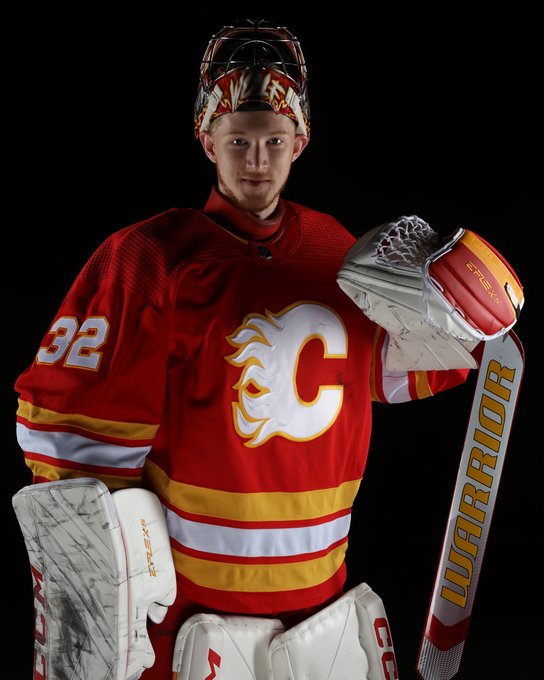 Dustin Wolf wearing a red Flames jersey.