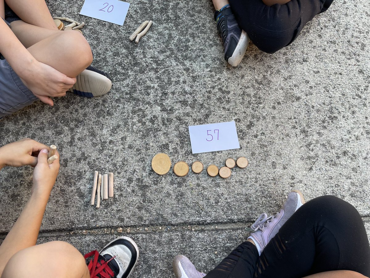 Yesterday, we took our Math lesson outside and the kids practiced building 2 digit numbers using wooden sticks for tens and tree cookies for ones. They discussed what number they represented and how many tens and ones were in the number.💚<a href="/LHECMES/">Lincoln HeightsECMES</a> #ROOTEDinSuccess