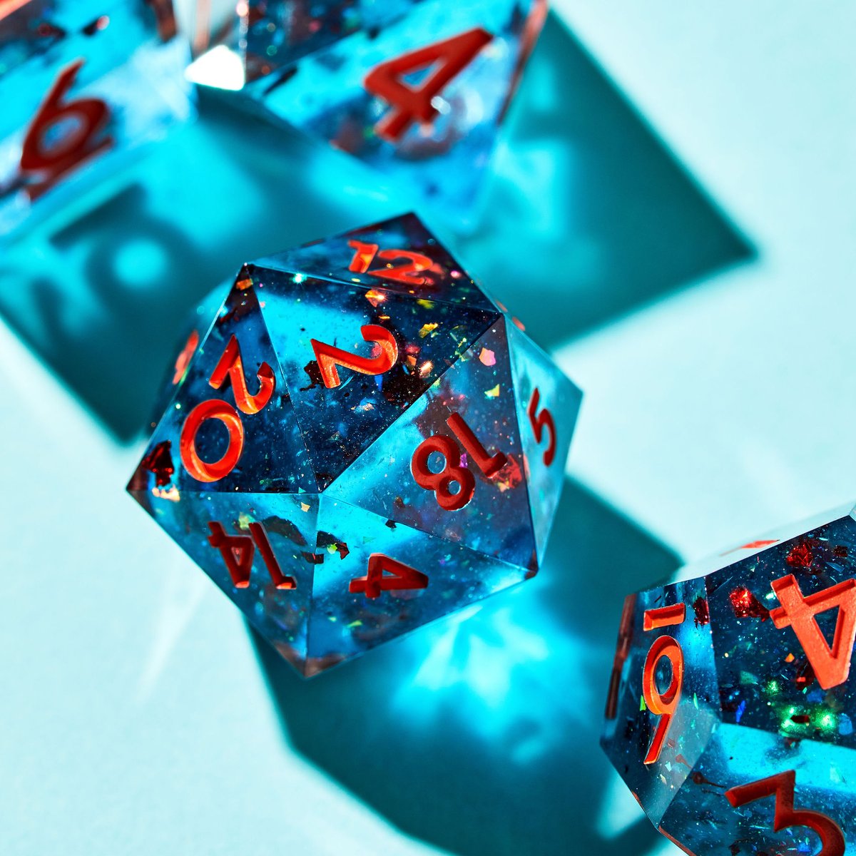 dispeldice's tweet photo. 🚀 The Shortest Distance 🚀

What do you think? 

A punchy dice set suspended red foil flake inside of a crystal clear blue base, inked in matte orange numbers. 

Cyberspace drops @ 11/16 at 12PM PT, 11AM PT for Early Access. Sign up for our mailing list for EA! https://t.co/yTbUBKQ3AM