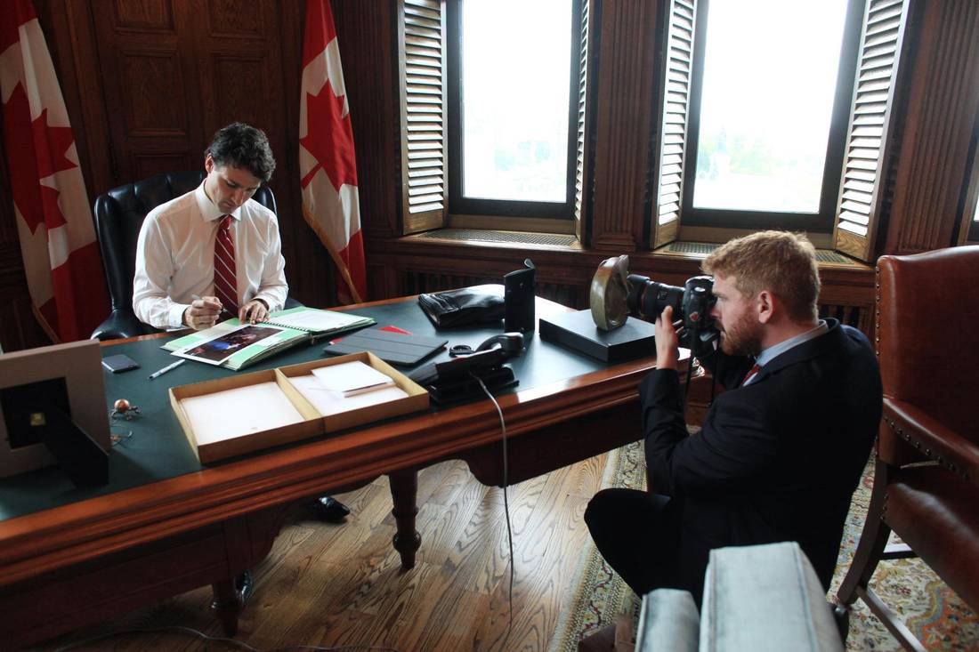 Kauwhaka's tweet photo. @Freecanuck1 Trudeau Trudeau certainly likes cameras! Here's a photo of his photographer taking a photo of him while he signs a photograph of... himself. #TruDouche https://t.co/Gw4K1LezVF