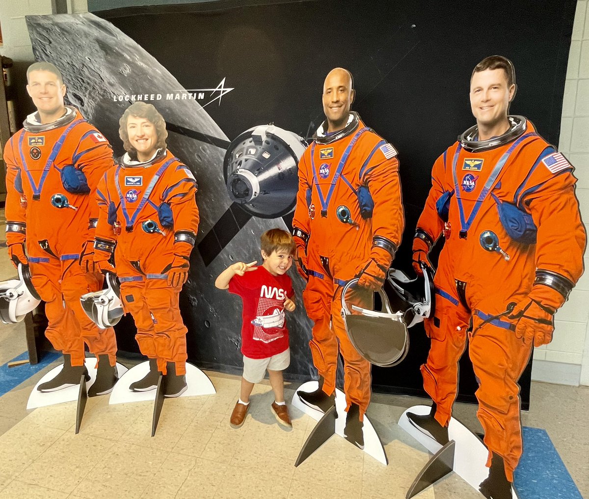 spacecitychick's tweet image. Aspiring astronomer and astronaut Ezra strikes a pose at a photo op with life-size images of the #Artemis II crew @NASAStennis Day at the Bay. The crew will fly around the Moon and back on the @NASA_Orion spacecraft. #LMSpace