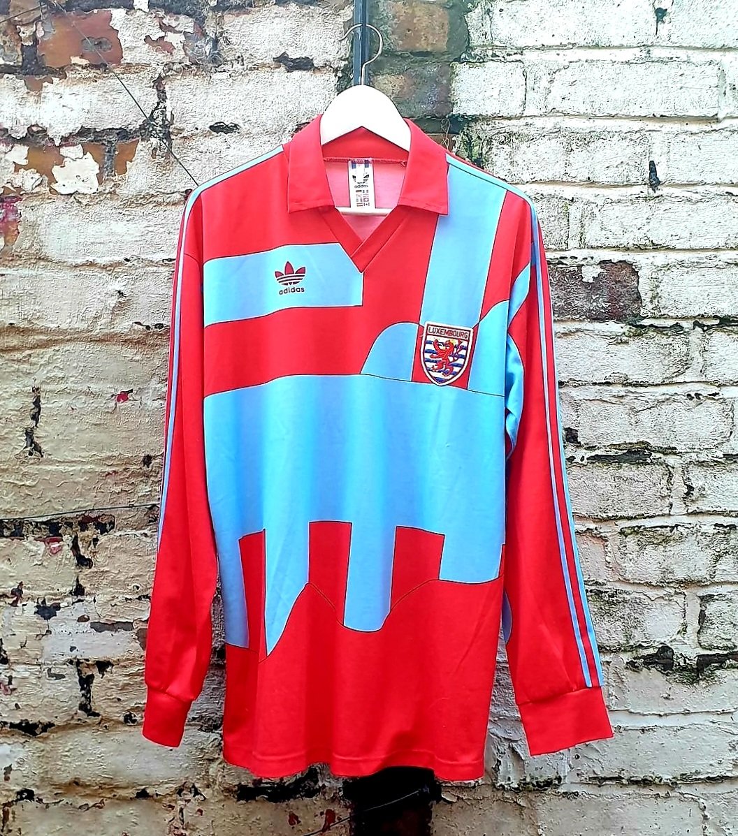 Bought quite a few shirts during my recent hiatus. I'll be showcasing them in due course.

Here's one of my favourites - the 1993 Luxembourg away. Adidas deploy their rather chaotic 'Ideal' template with a truly wonderful red &amp; blue-grey colourway (Cremonese eat your heart out).