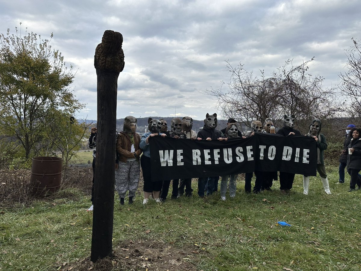 ClimateCorpsPgh's tweet image. Clairton, PA: Ceremonial planting of an Externality carved from a tree burned in PNW wildfires. Overlooking one of the biggest industrial contributors to climate change in PA courtesy of US Steel. #WeRefuseToDie  Worst AQ in the country today too.
