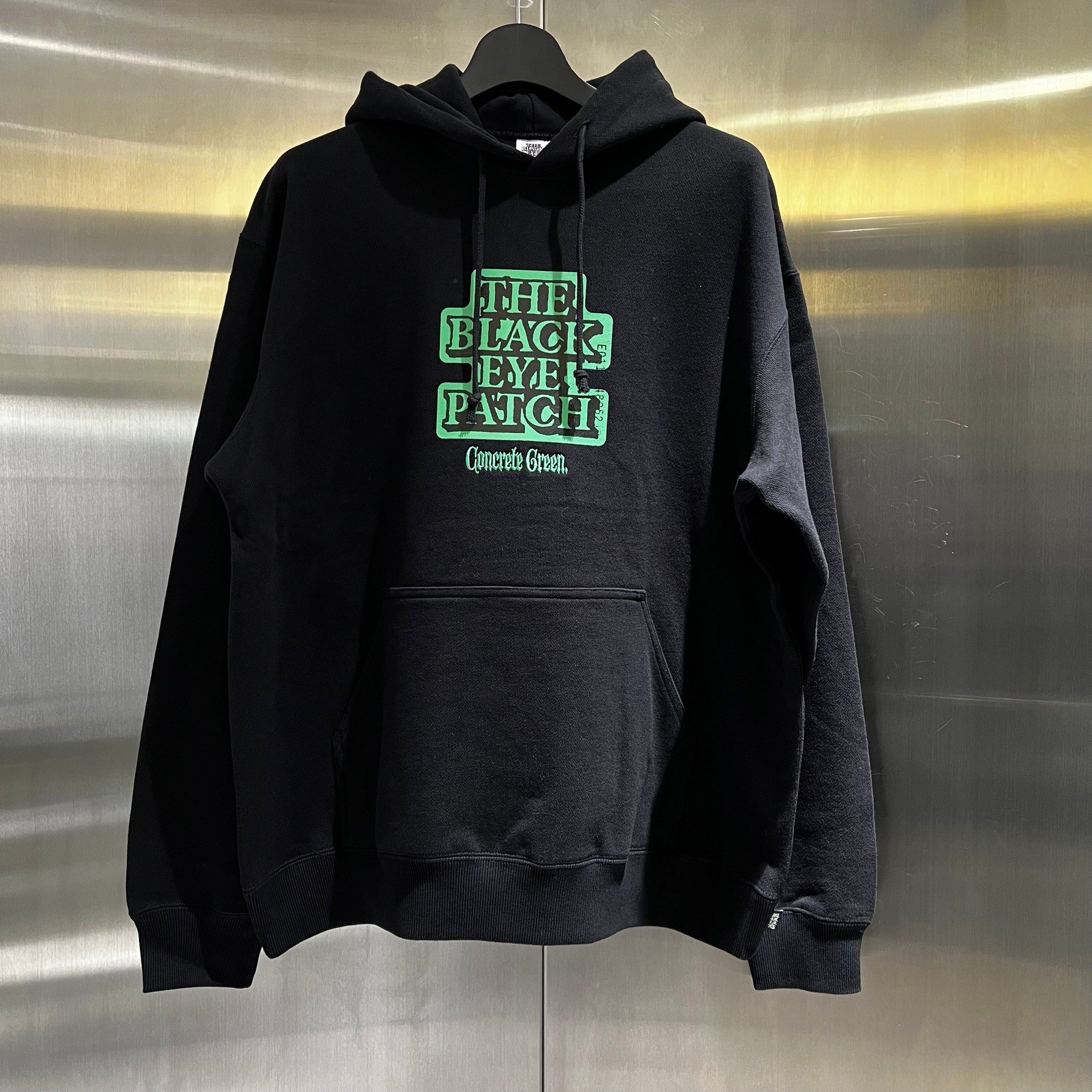 black eye patch concrete green hoodie