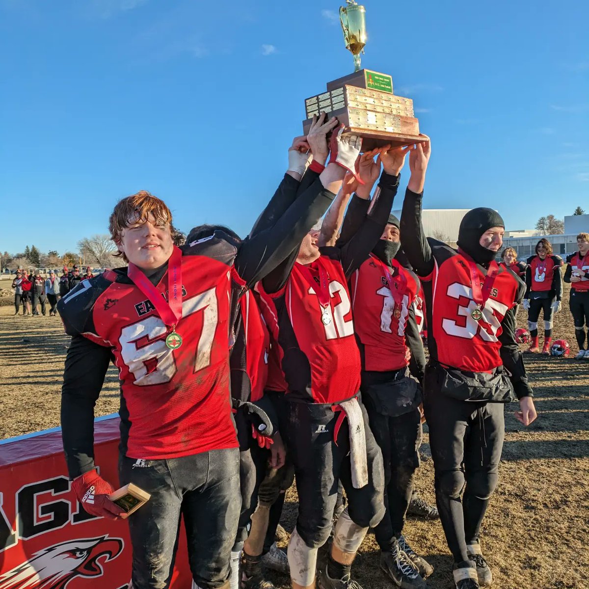The captains of the Weyburn Comp Eagles lifted the provincial championship trophy after defeating Saskatoon Aden Bowman 35-15