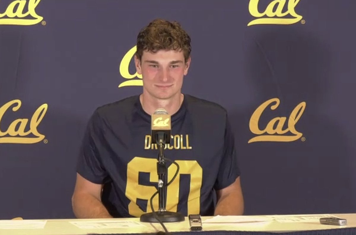 Cal QB Fernando Mendoza wearing a Brian Driscoll shirt in the postgame press conference after the Bears’ win today. Driscoll, Cal’s starting center, scored a touchdown today in the victory over Washington State.