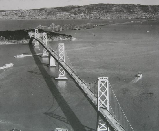 ICELibrary's tweet photo. San Francisco–Oakland Bay Bridge opened to traffic #OnThisDay  1936. Actually two bridges joined by a tunnel, originally they carried both road and rail.  The Eastern section was replaced in 2013. https://t.co/g8Jy9pSDnm