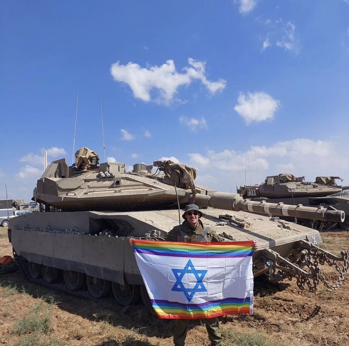 DavidSaranga's tweet photo. Yoav Atzmoni:

“My intention was to plant the first pride flag in Gaza as a call for peace and as a message of freedom”

“Before entering Gaza, I asked my partner to bring me two pride flags: The first is an Israeli flag in pride colours that I pose with on a tank. It sends two messages:

There is an internal message to Israel: that we carry obligations towards the state and must demand gay rights here - not necessarily to marry and start a family, but something more basic - the right to security as LGBTQ people, the right to respect, the right to be part of the national ethos, the right to be counted and recognized

The external message to the world is that despite the pain of war - the IDF is the ONLY army in the Middle East that defends democratic values. It is the ONLY army that allows gay people the freedom to be who we are. And so I fully believe in the righteousness of our cause.

The second flag is a simple pride flag that represents global solidarity. 

When I entered Gaza, I knew I would write a message in three languages, but I hadn't yet decided what to say. (I should mention that I speak both spoken and literary Arabic). 

In the early days of the conflict I saw the Arabic inscription 'Bismillah' ('In the Name of God') on many houses

I decided to correspond with this by writing "Bismilahav" - which means "In the Name of Love" 

Additionally, 'In the Name of Love' is a song by the band U2 that I really like!”

#LGBT #LGBTQ #LGBTQIA