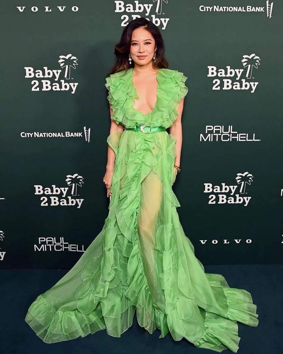 Christine Ko wears a green floor-length chiffon gown with ruffle detail and belt from the #ZuhairMuradRTW Pre-Fall 2023 collection to the @baby2baby Gala. Styled by @robzangardi @MARIELhaenn #ZuhairMurad