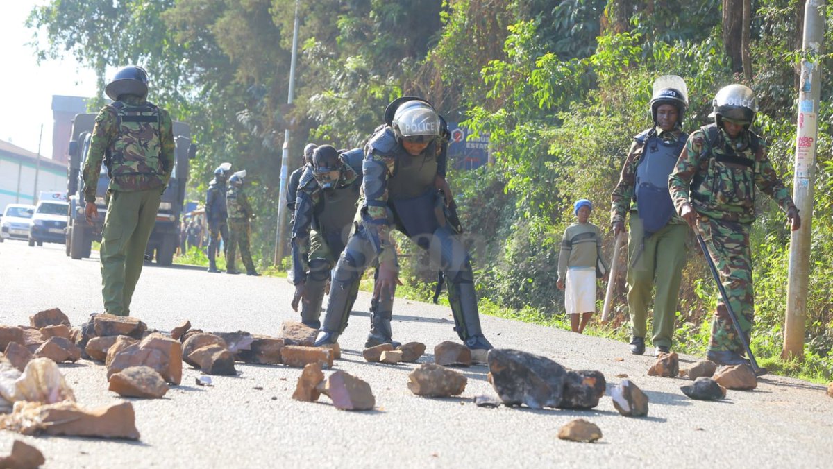 Police officers patrol along the Kisii-Migori highway, remove stones thrown on the road during anti-government protests Pictures: Sammy Omingo #MaandamanoWednesday