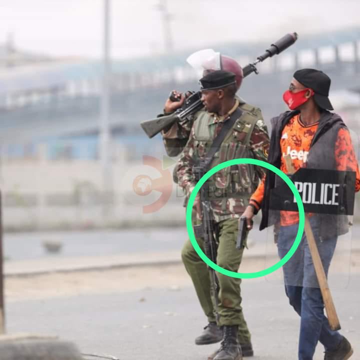 Who is this guy in civilian clothes and why is he carrying a pistol?