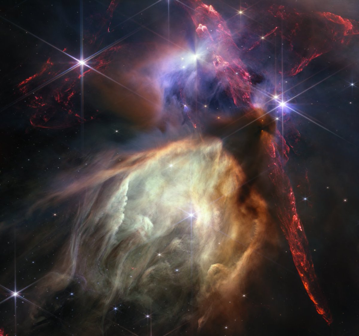 Here it is: @NASAWebb’s one-year anniversary image. Called Rho Ophiuchi, this area shows about 50 young stars in a cocoon of gas and dust. At 390 light-years away, it's the closest star-forming region to Earth: go.nasa.gov/3rqX8Tl Webb continues to #UnfoldTheUniverse.