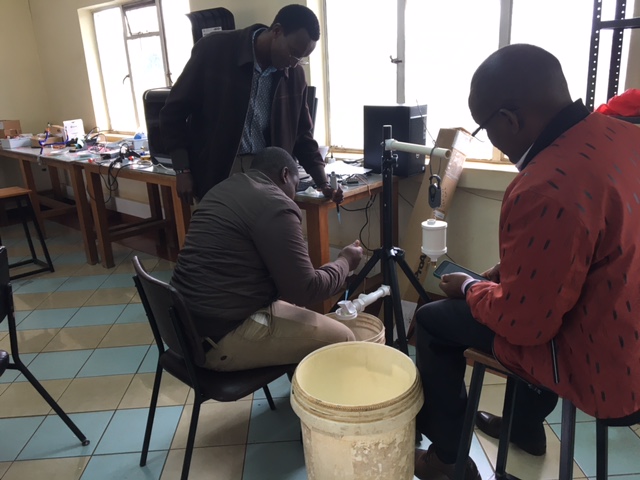 COMETMetEd's tweet photo. Members of the @MeteoKenya (KMD) calibrate a tipping bucket rain gauge for the 3D-PAWS (3D-Printed Automatic Weather Station). Martin Steinson of COMET has been working with the KMD to fabricate 3D-PAWS in support of the Famine Early Warning System Network (@FEWSNET ). https://t.co/RfzFOJvfcy